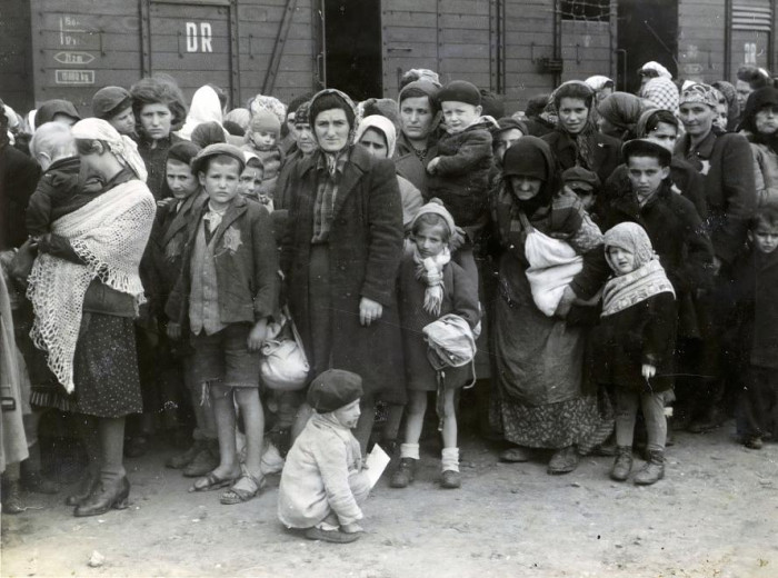 Sorban álló nők és gyerekek a vonat mellett, Auschwitz-Birkenau